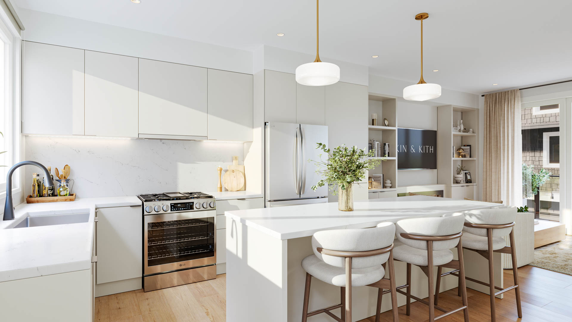Kin & Kith – A white contemporary kitchen with flat-panel cabinets, island with counter stools, brass pendant lights, and stainless steel appliances.